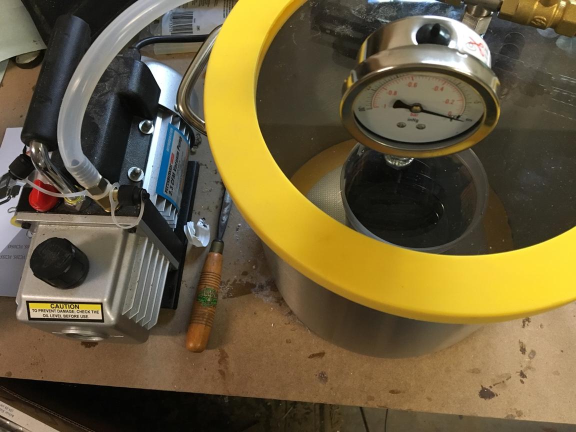Degas the silicone in a vacuum chamber