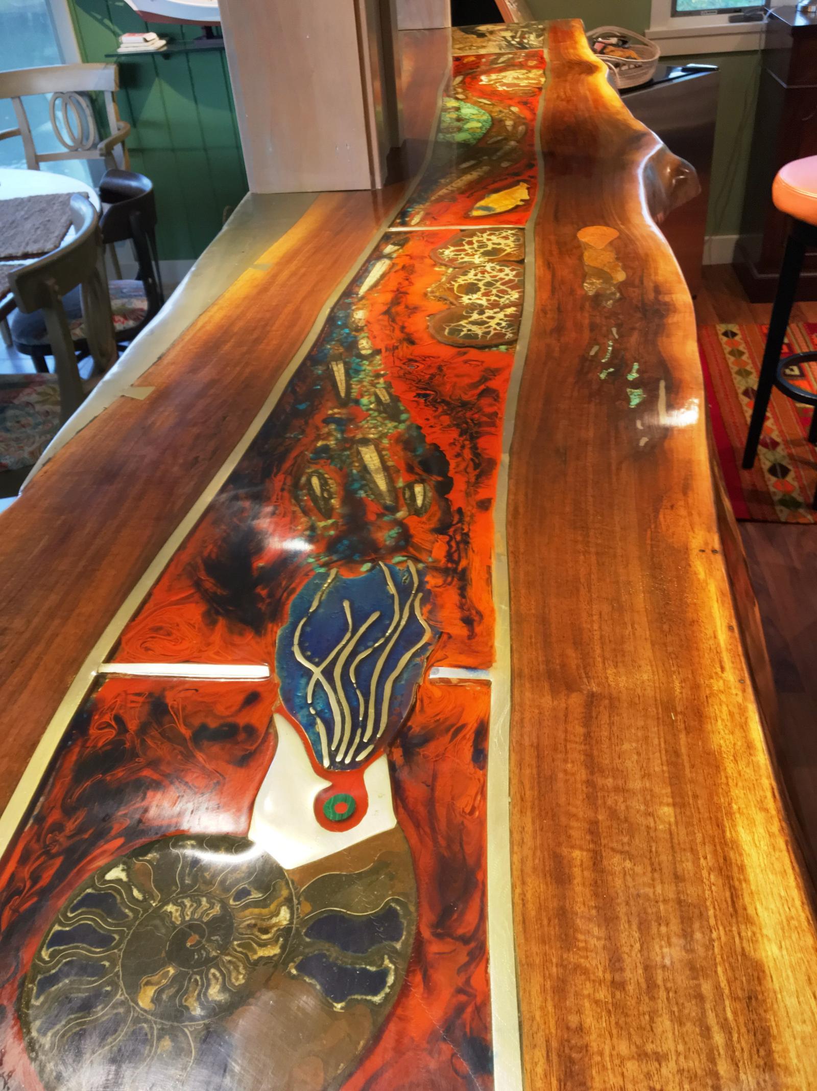 The fossil bar up close: ammonites and inlay in walnut, built by the owner.
