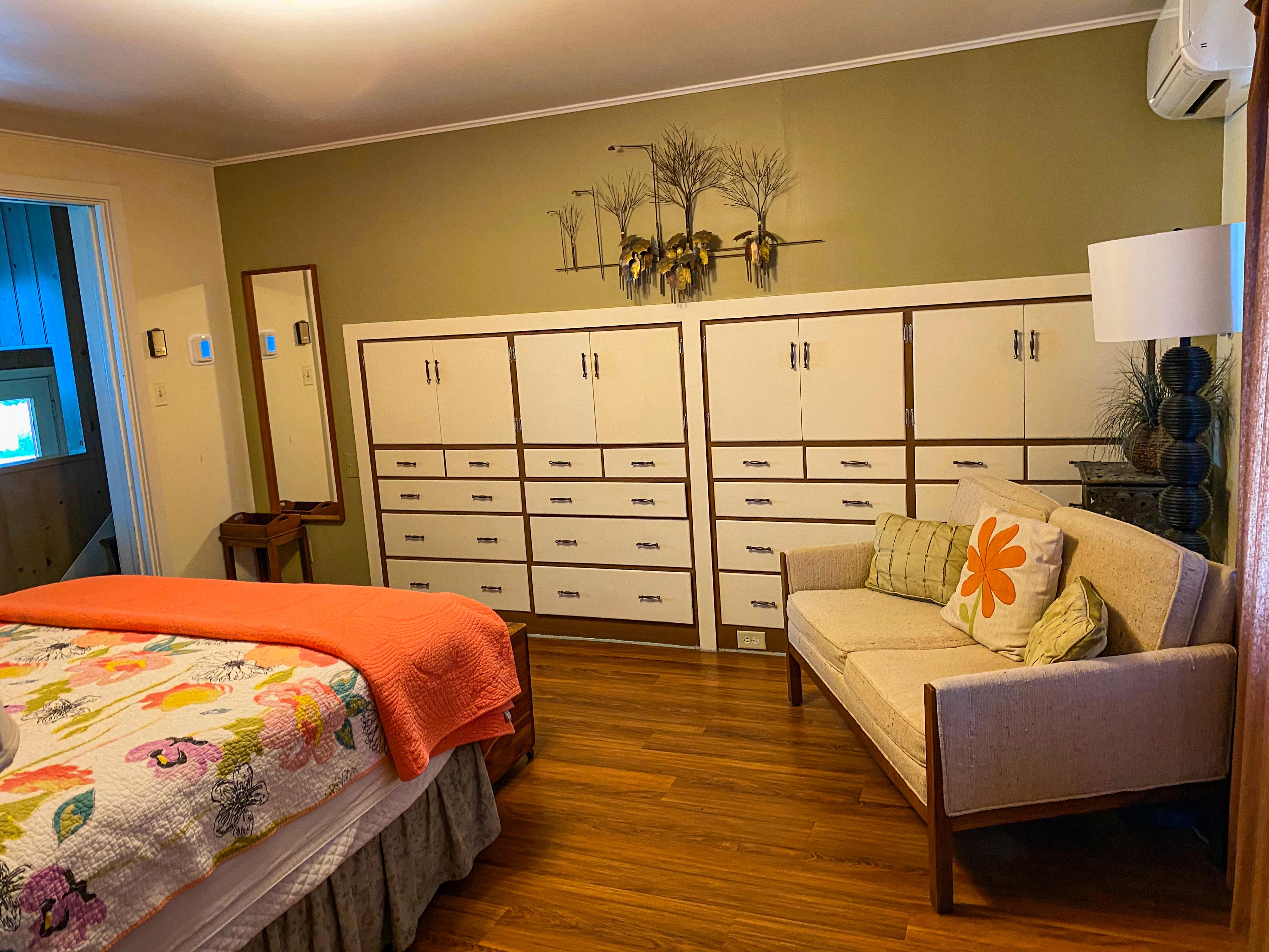 The master's wall of built-in cabinets, with the sitting corner's couch beside them.